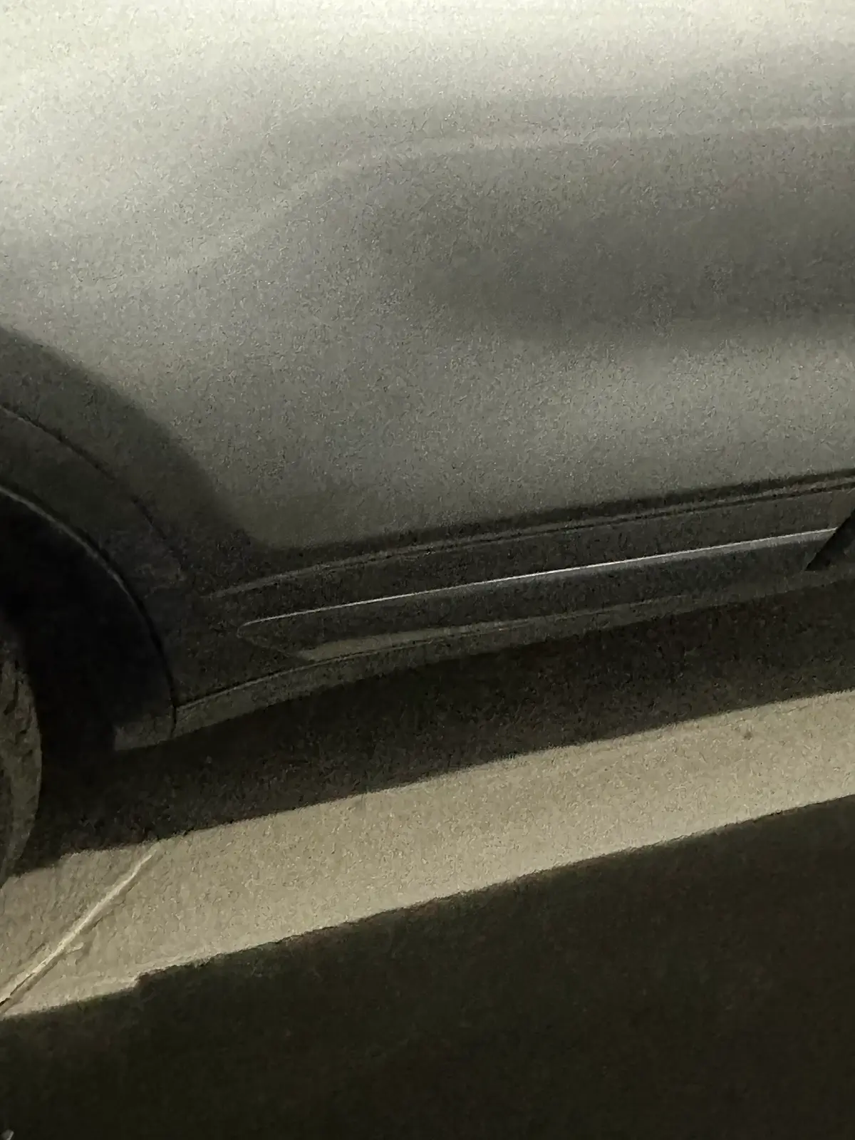Vehicle panel with a dent removed by paintless dent repair at AutoStyle Collision